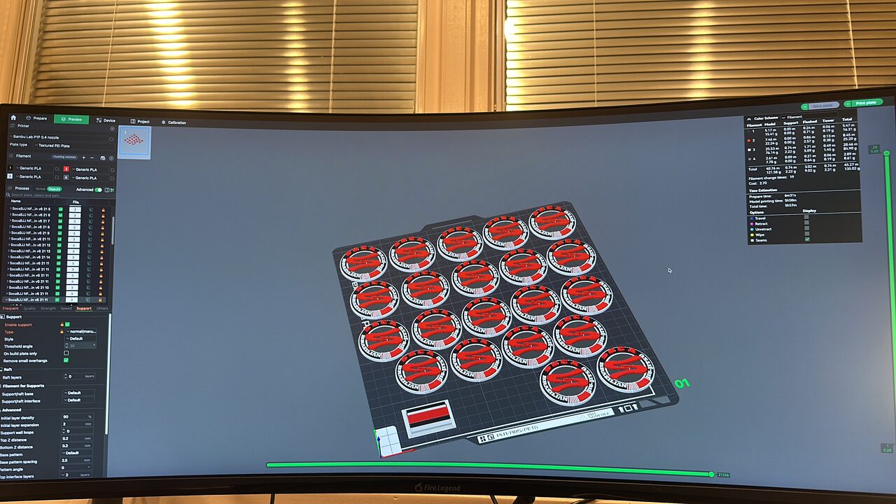 A curved monitor showing slicer software with a build plate laid out with twenty round Soca Brazilian Jiu-Jitsu medallions.