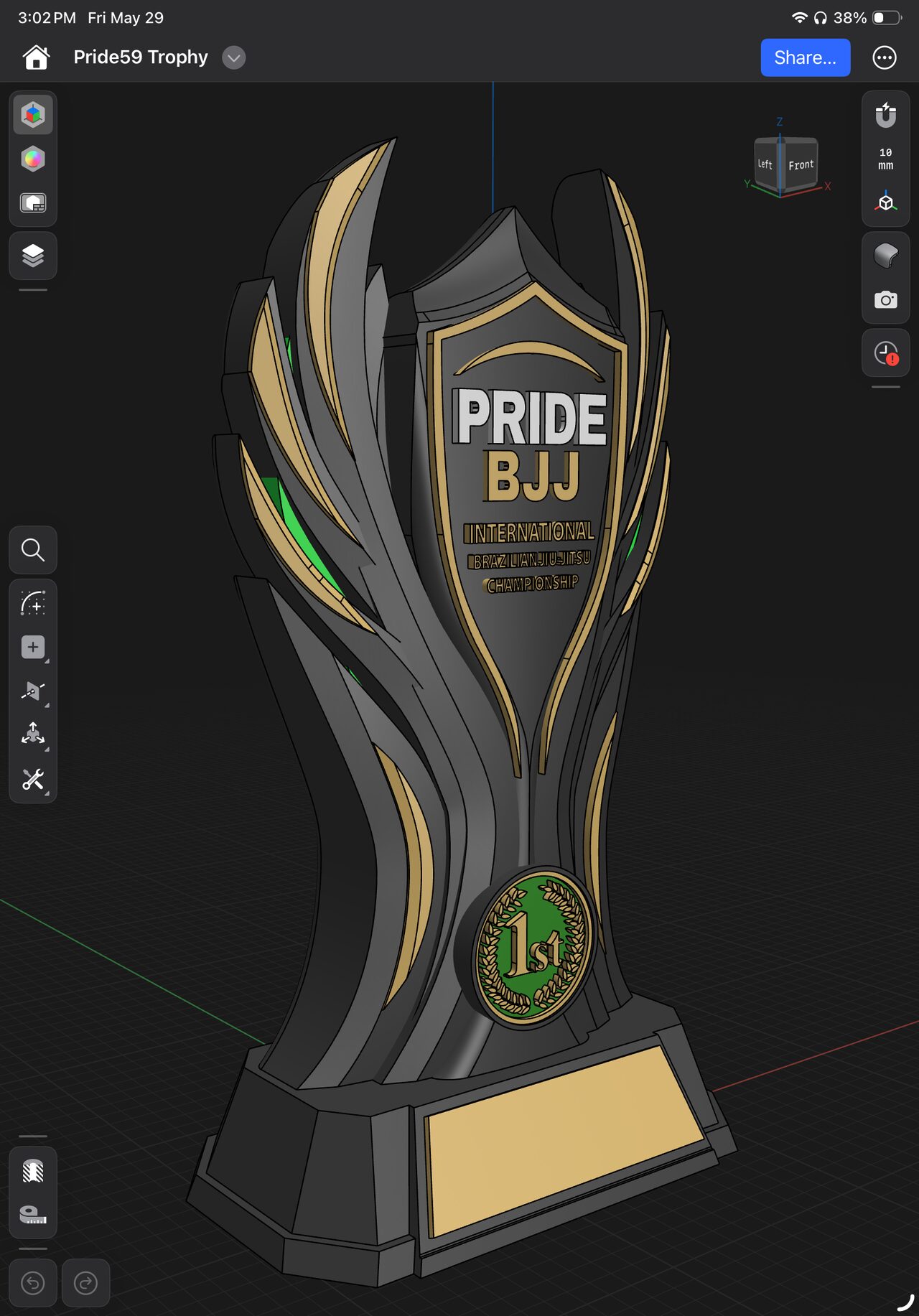 Tablet CAD screenshot of the trophy model: dark wing blades with gold and green accents, a shield with Pride BJJ lettering, a round 1st medallion and a blank base plate.